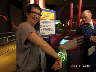 Using my MagicBand to enter the FastPass line at Soarin'. Note the screen in the center. This tells the cast member my name and other information. This may lead to less sharing of FastPasses among family members. 
