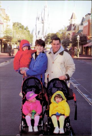 You can't see it, but there's a buggy board clipped to the back of one of those strollers. With three small kids, this was our method of choice for many years of Disney visits.