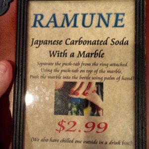 Ramune Sign at Epcot Japan, advertising soda sealed with a marble and opened by pushing the marble down breaking the seal.