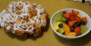 The "appetizer" is a massive cinnamon roll bake and a large dish of fruit. Photo by Julia Mascardo