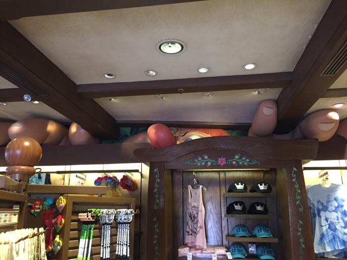 The Giant peaks inside Sir Mickey's merchandise shop