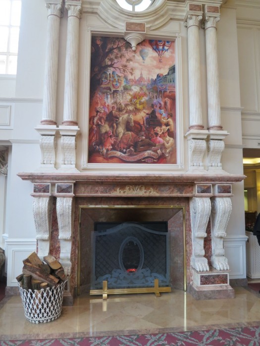A huge mural lies above a high fireplace adjacent to the registration nook.