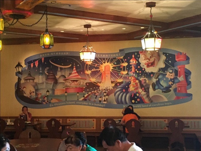 Pleasure Island mural and candy-themed lights in Pinocchio Village Kitchen