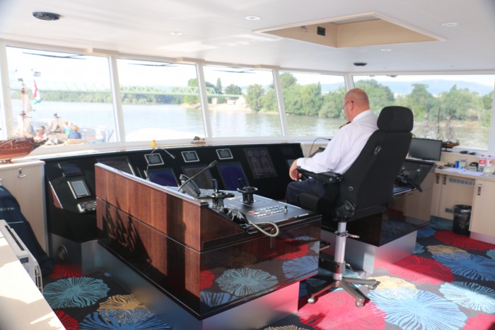 The captain on the Navigation Bridge. Guests are often able to join the captain to learn more about the ship. 