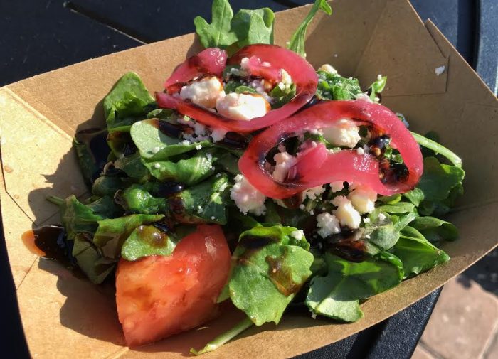 Urban Farm Eats' watermelon salad with pickled onions, arugula, feta cheese, and balsamic reduction