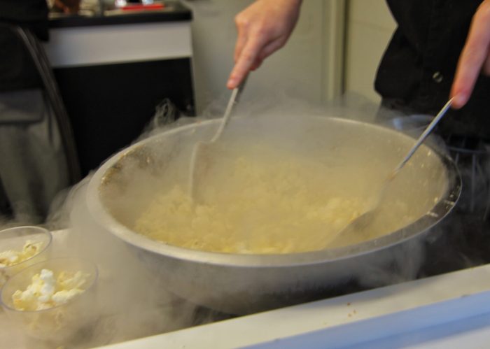 Chefs prepare liquid-nitrogen-frozen popcorn in the Carnival section of the Food & Wine Classic