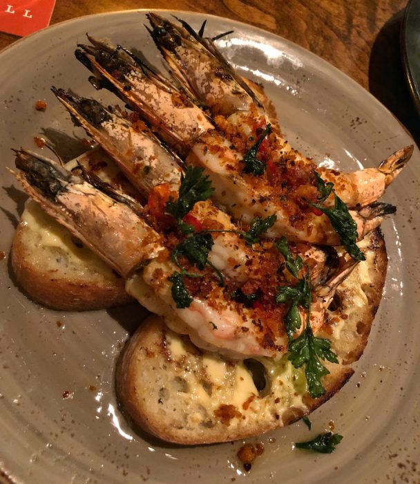 Wood-grilled shrimp with garlic toast and nduja bread crumbs